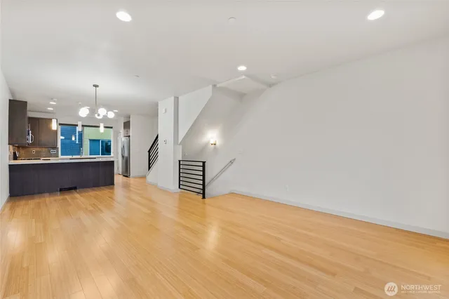 a view of kitchen and hall with wooden floor