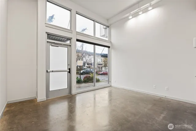 a view of a livingroom with wooden floor and a window