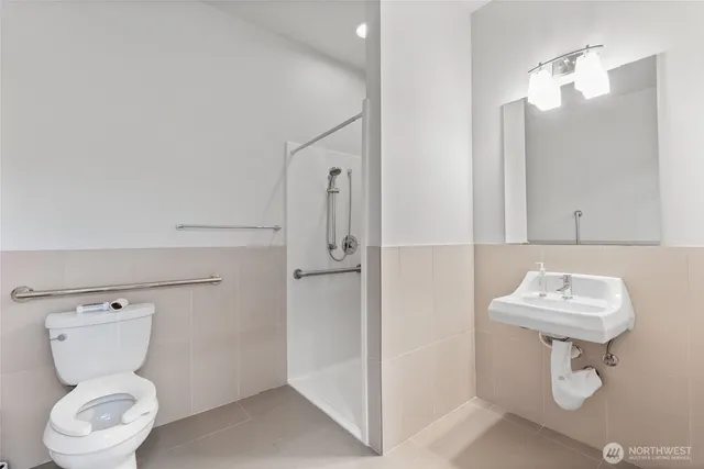 a bathroom with a toilet sink and mirror