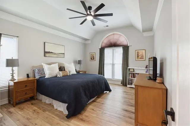 a bedroom with bed and wooden floor