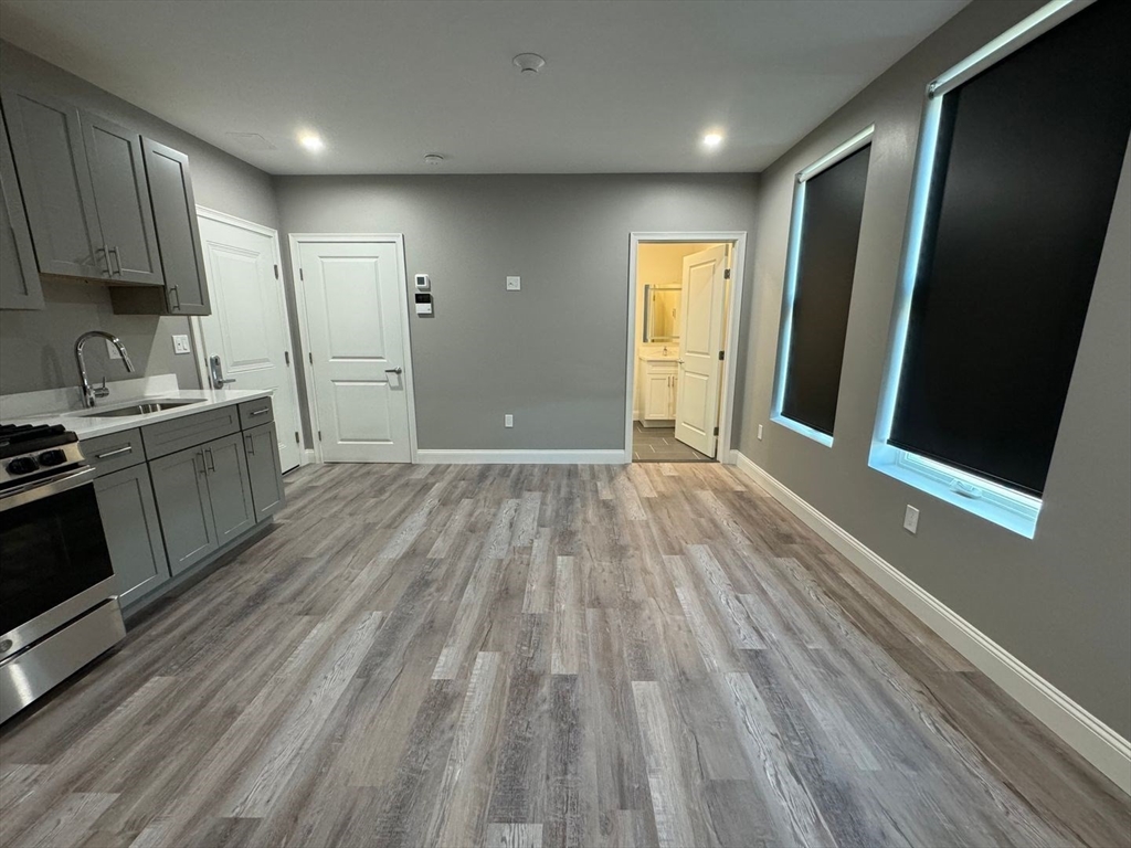 55 Walnut Avenue, Unit 103 Revere, MA 02151 - Photo 5 of 7 a view of a kitchen with wooden floor