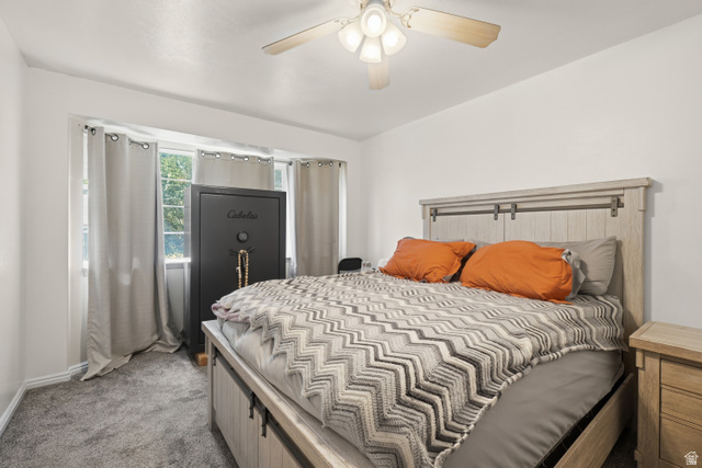 2135 East White Pine Road Eagle Mountain, UT 84005 - Photo 14 of 23 Bright interior space featuring light gray carpet, a ceiling fan with integrated lighting, and multiple windows with light-filtering curtains