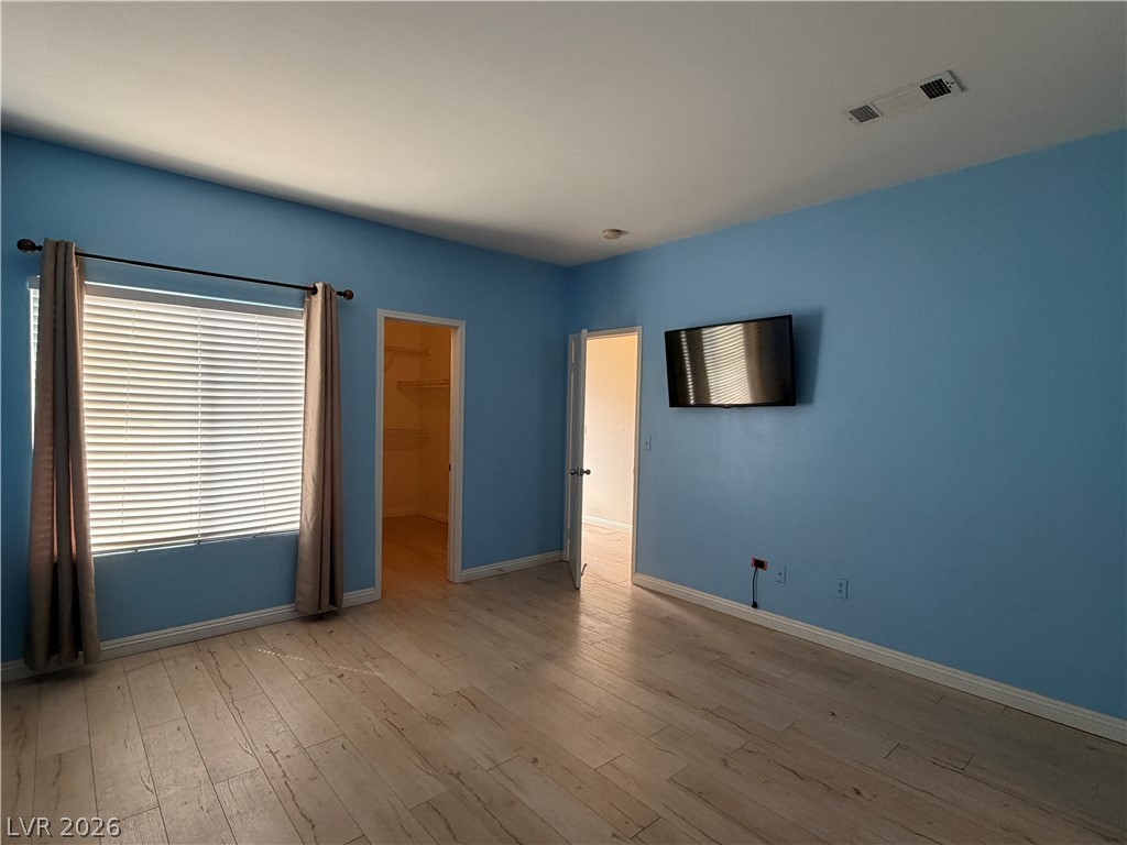 5525 West Flamingo Road, Unit 2016 Las Vegas, NV 89103 - Photo 15 of 20 Unfurnished bedroom featuring a spacious closet and light wood finished floors