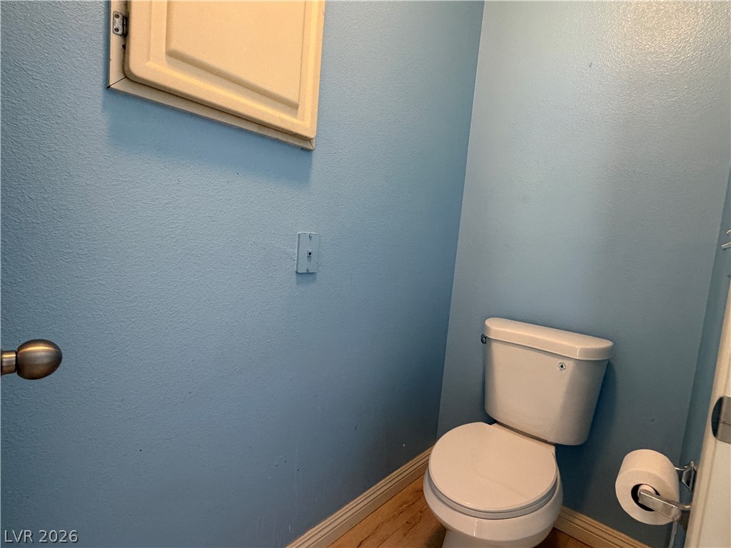 5525 West Flamingo Road, Unit 2016 Las Vegas, NV 89103 - Photo 17 of 20 Bathroom featuring wood finished floors and a textured wall