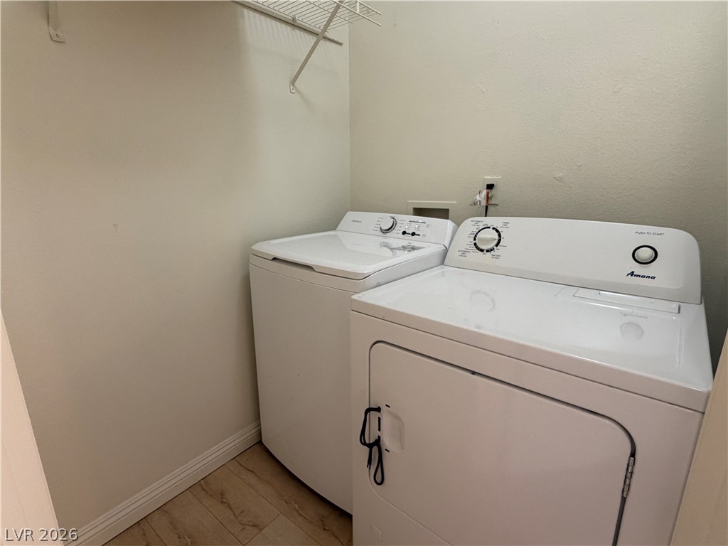 5525 West Flamingo Road, Unit 2016 Las Vegas, NV 89103 - Photo 19 of 20 Laundry area with washing machine and dryer and baseboards