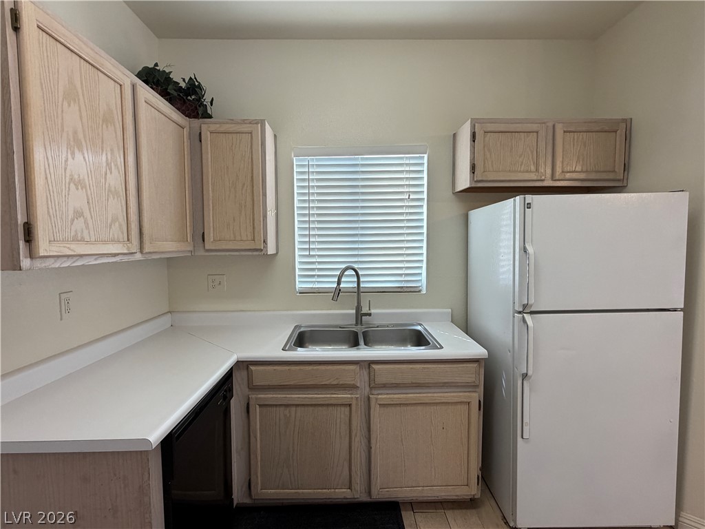 5525 West Flamingo Road, Unit 2016 Las Vegas, NV 89103 - Photo 7 of 20 Kitchen with freestanding refrigerator, light countertops, dishwasher, and light wood finish cabinets