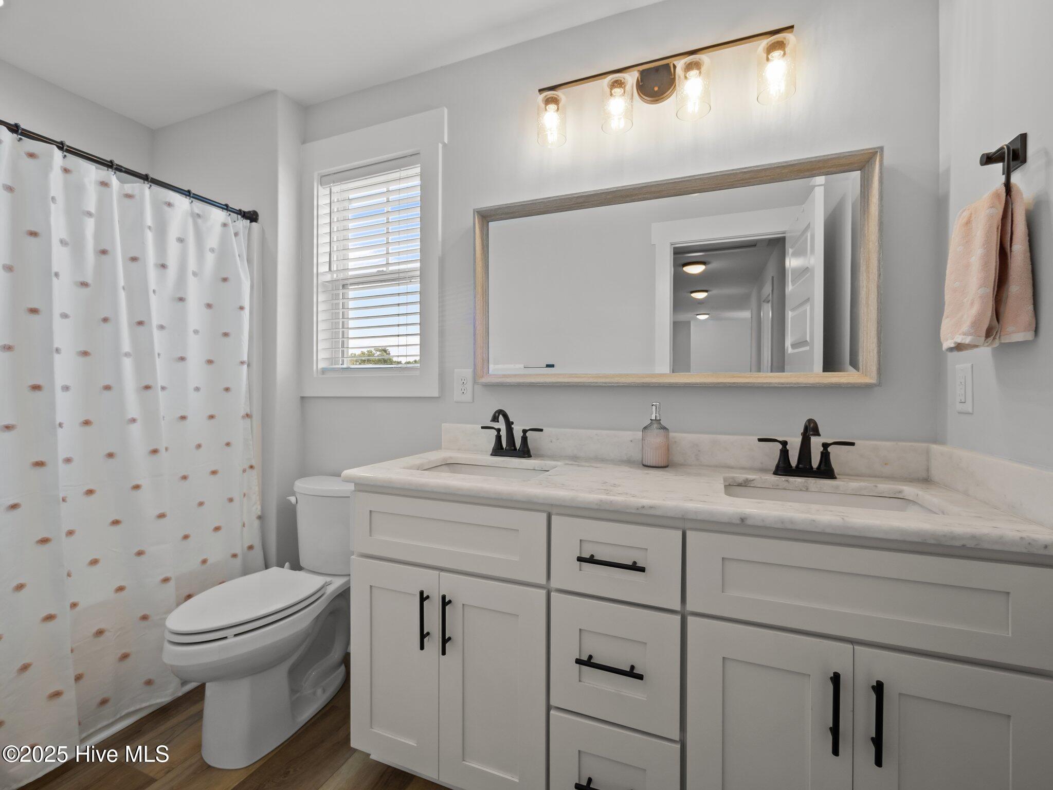 208 Coastline Circle Cedar Point, NC 28584 - Photo 45 of 66 Hall Bathroom with double sinks for Bedroom 3 and Bedroom 4