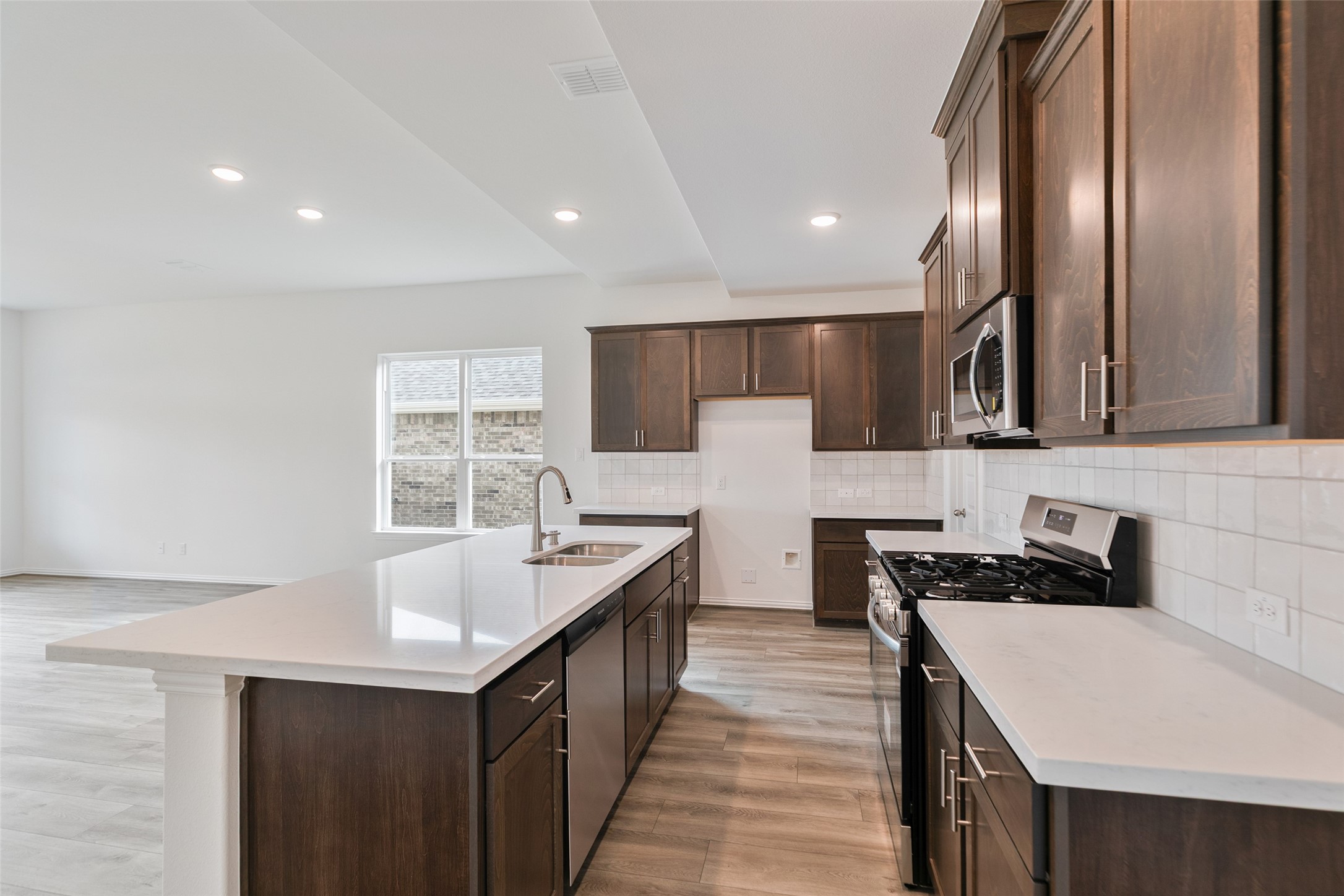 2710 Alexis Street Seabrook, TX 77586 - Photo 12 of 46 a kitchen with stainless steel appliances a sink stove and cabinets