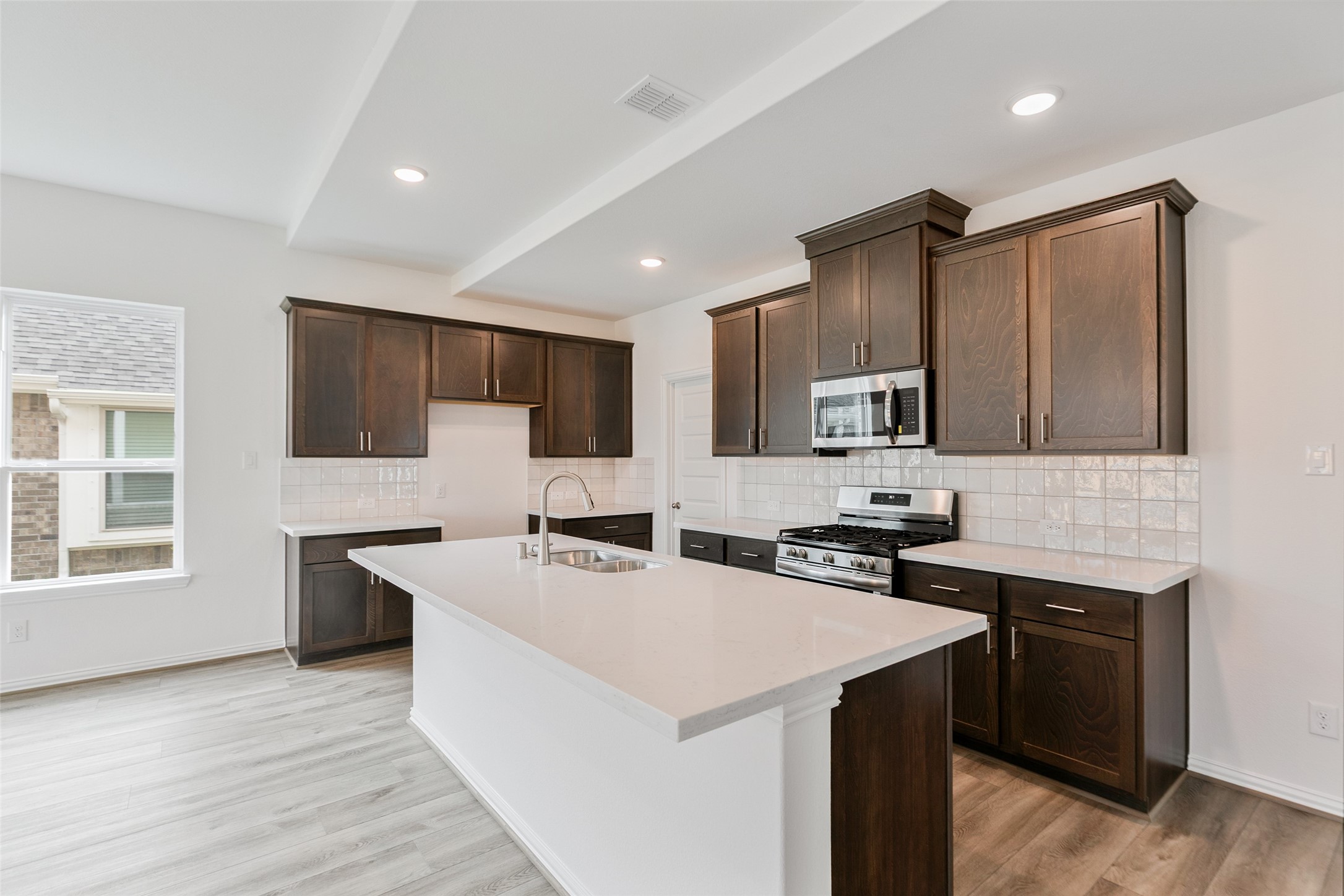 2710 Alexis Street Seabrook, TX 77586 - Photo 13 of 46 a kitchen that has a sink a stove and chairs