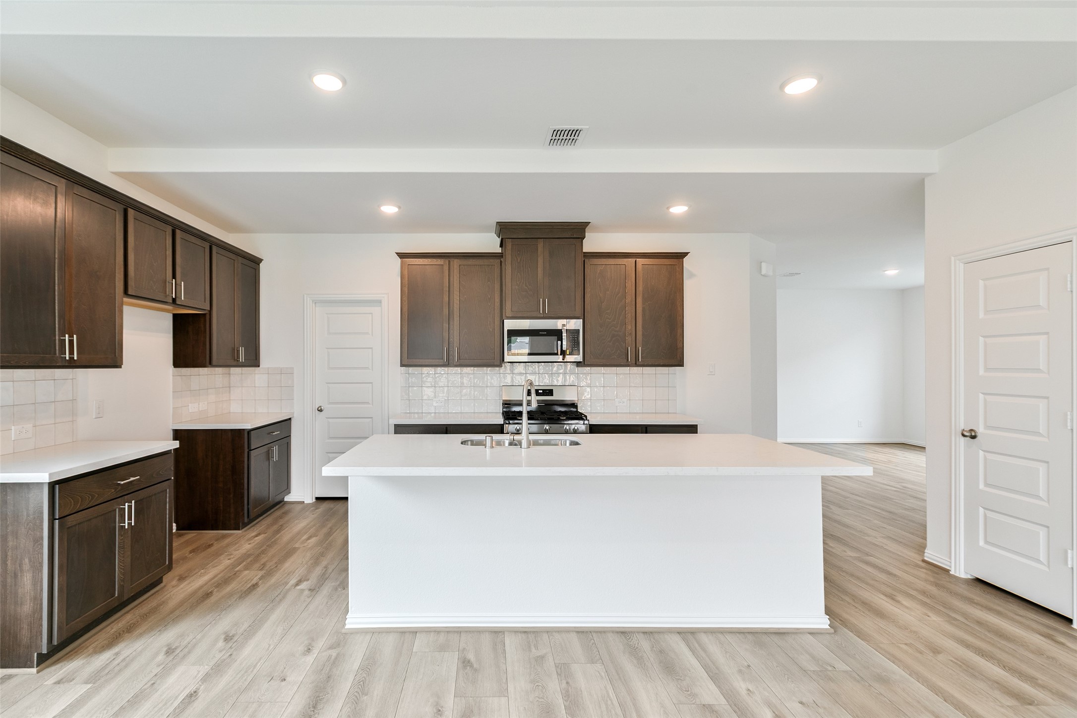 2710 Alexis Street Seabrook, TX 77586 - Photo 15 of 46 a large kitchen with stainless steel appliances a large counter top a stove and a refrigerator