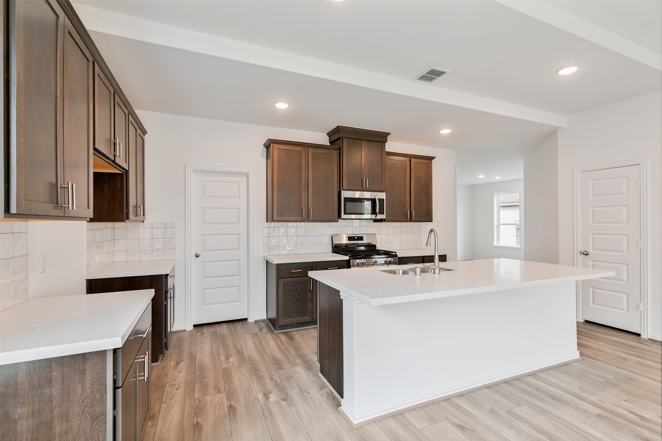 2710 Alexis Street Seabrook, TX 77586 - Photo 16 of 46 a kitchen with stainless steel appliances a sink stove and refrigerator