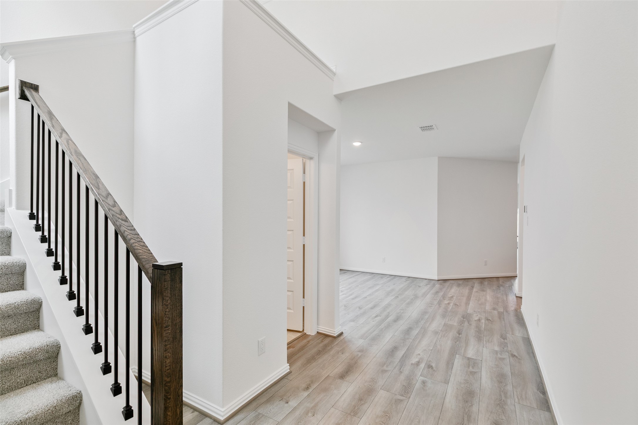 2710 Alexis Street Seabrook, TX 77586 - Photo 5 of 46 a view of a hallway with wooden floor and stairs