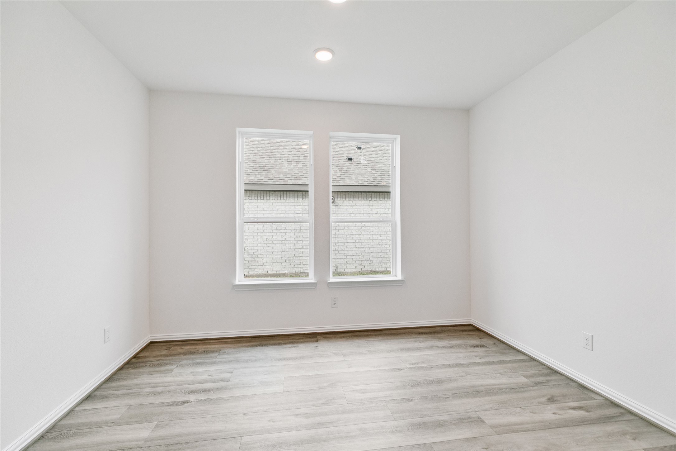 2710 Alexis Street Seabrook, TX 77586 - Photo 8 of 46 an empty room with wooden floor and windows
