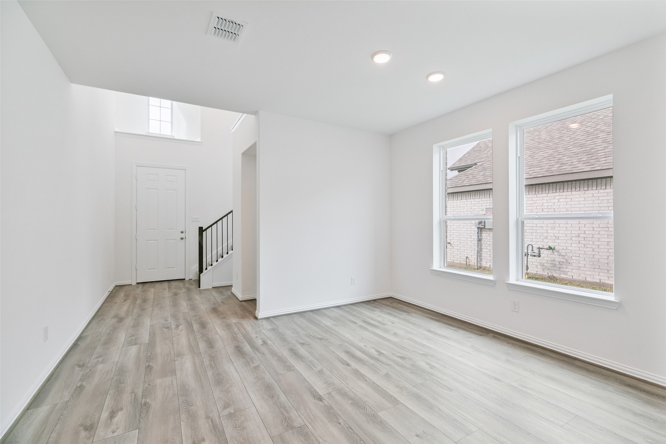2710 Alexis Street Seabrook, TX 77586 - Photo 9 of 46 an empty room with wooden floor cabinet and windows
