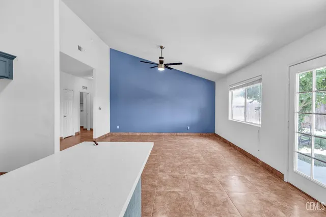 a view of a livingroom with a ceiling fan and window