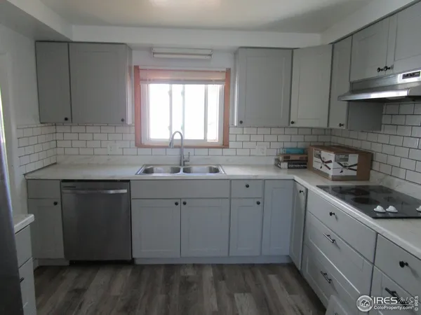 a kitchen with sink cabinets and window