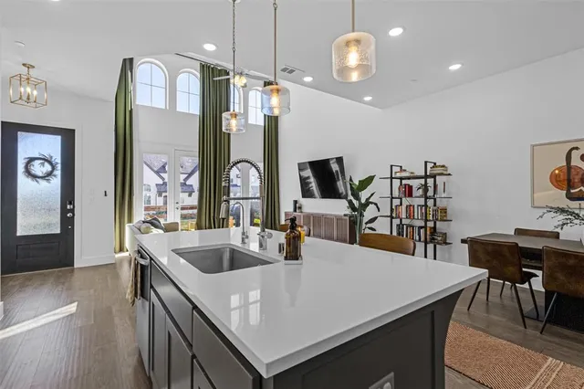 a kitchen with stainless steel appliances a sink a stove and a wooden floors