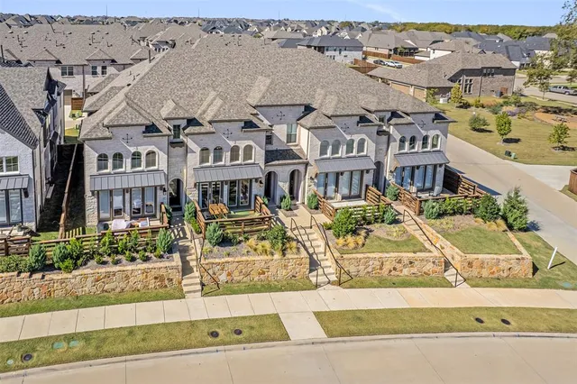 an aerial view of a building with a garden and mountain view