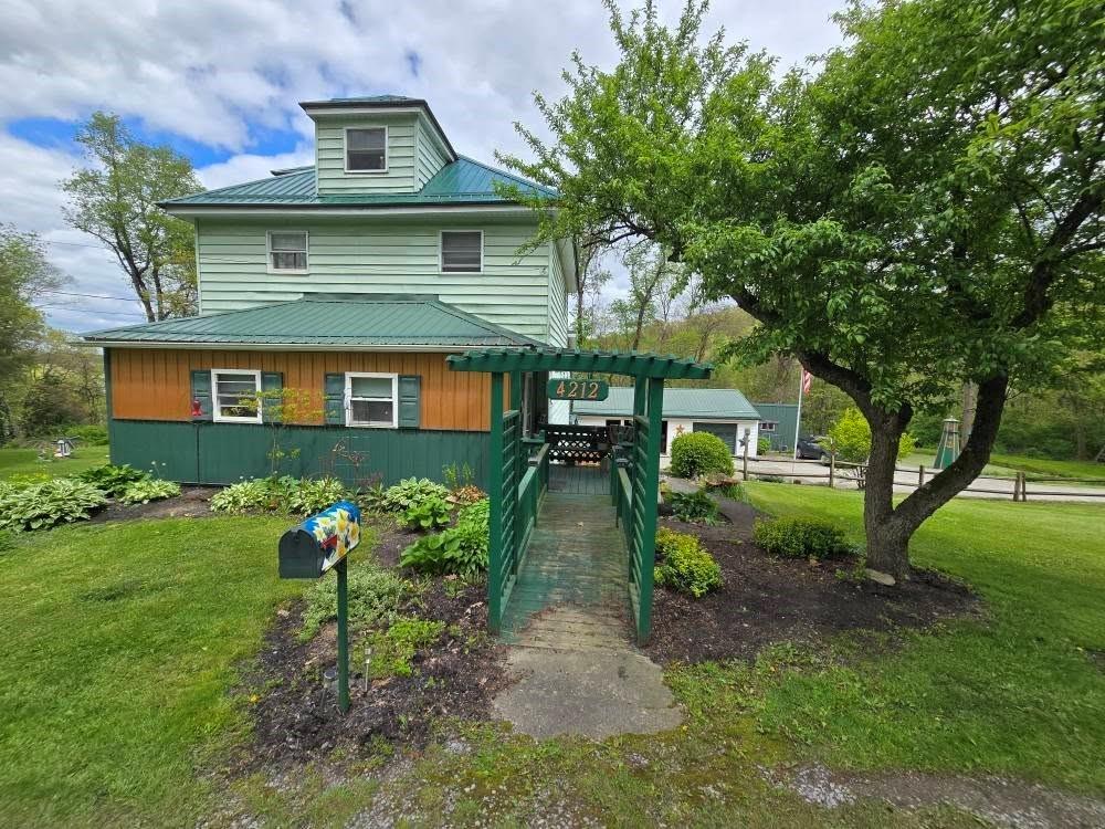 a front view of a house with garden