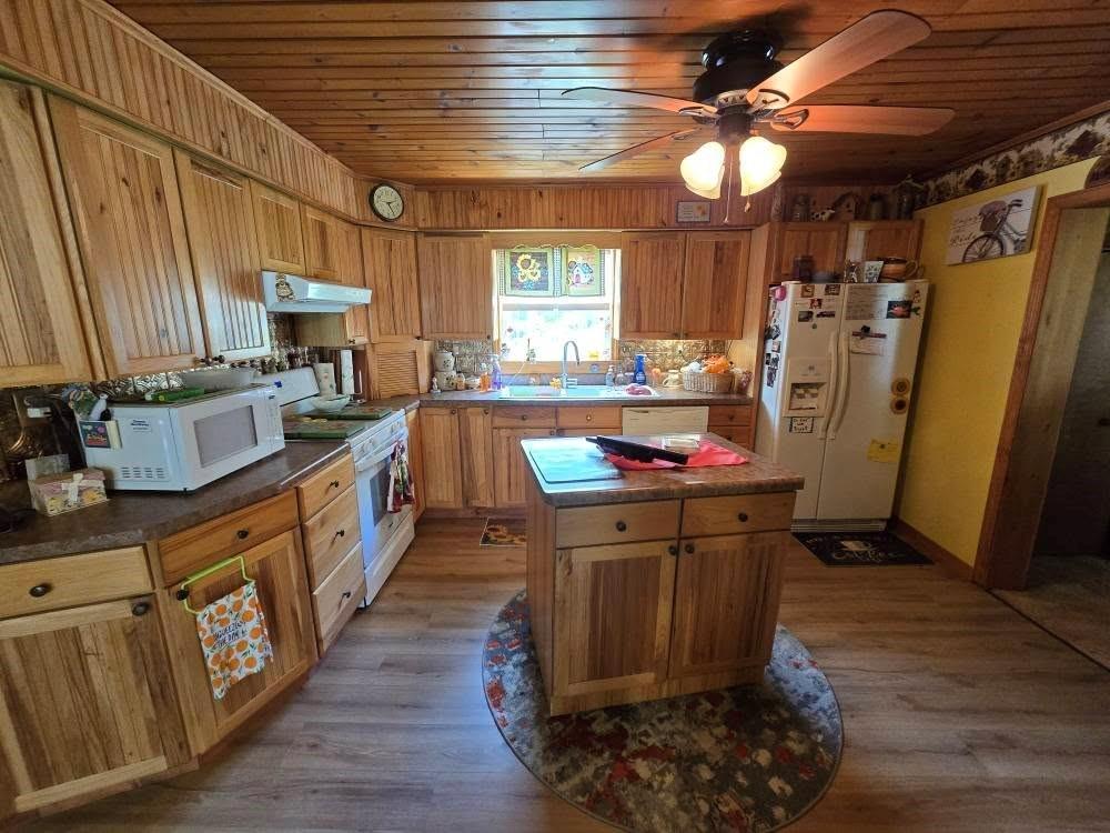 4212 Dayton Road New Bethlehem, PA 16242 - Photo 18 of 31 a kitchen with wooden cabinets and refrigerator