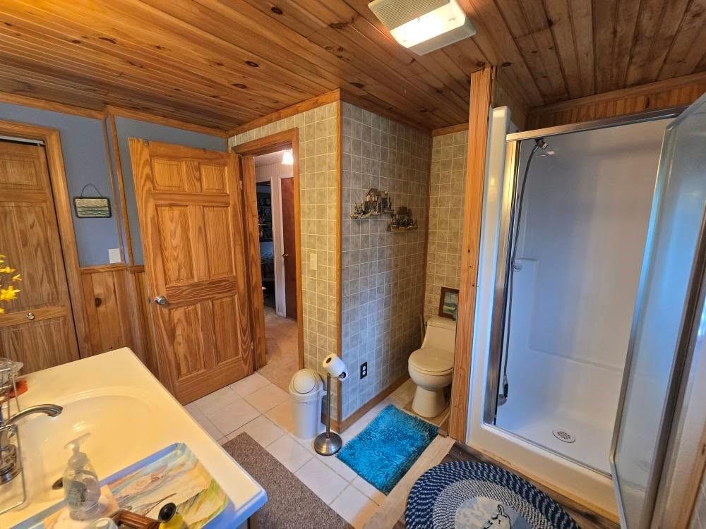 4212 Dayton Road New Bethlehem, PA 16242 - Photo 27 of 31 a bathroom with a granite countertop shower and a toilet