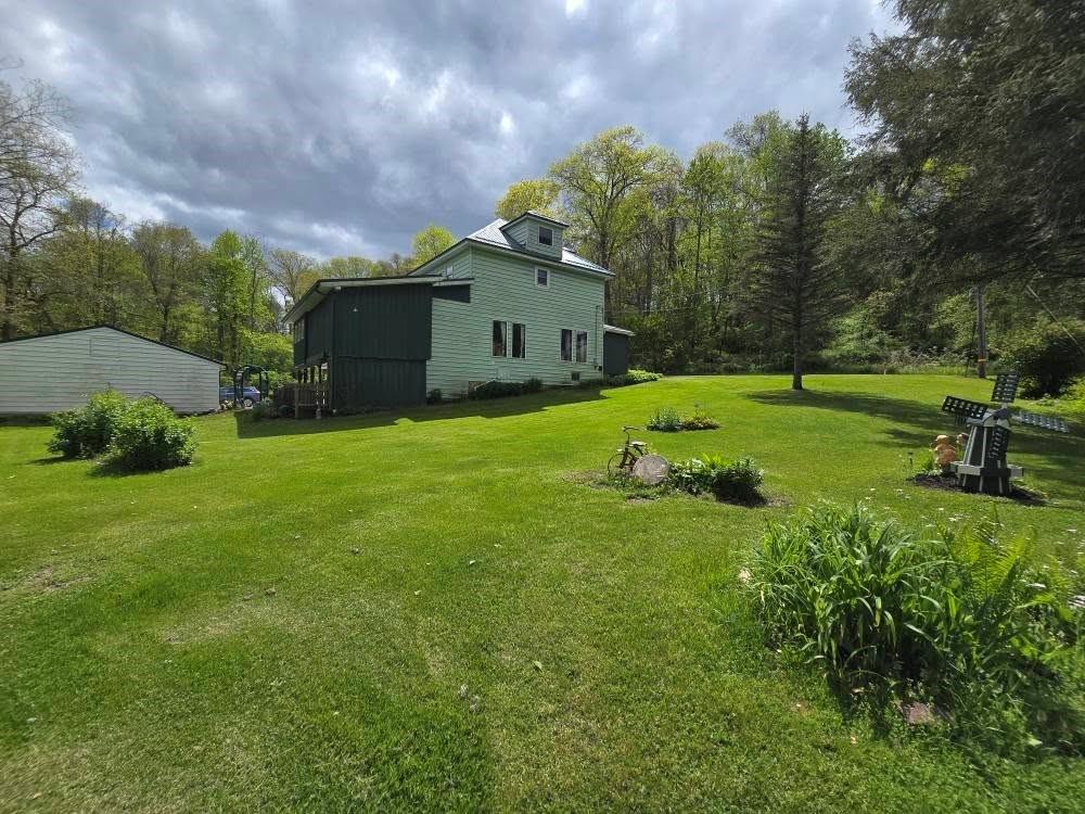 4212 Dayton Road New Bethlehem, PA 16242 - Photo 3 of 31 a yellow house in middle of the green field