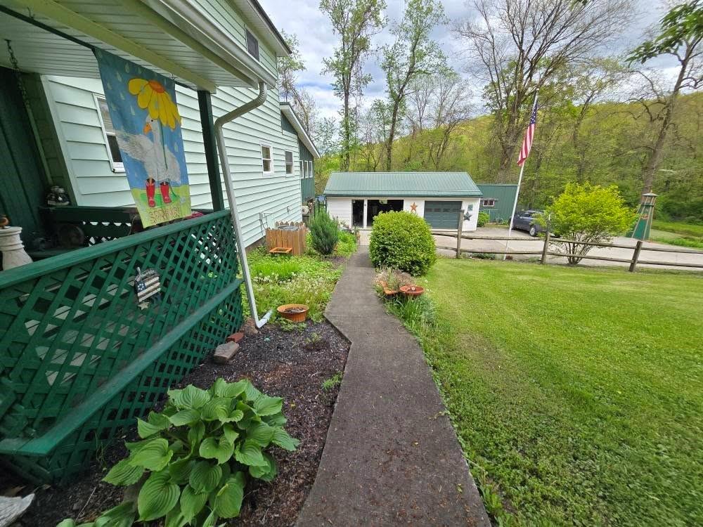 4212 Dayton Road New Bethlehem, PA 16242 - Photo 7 of 31 a front view of a house with garden