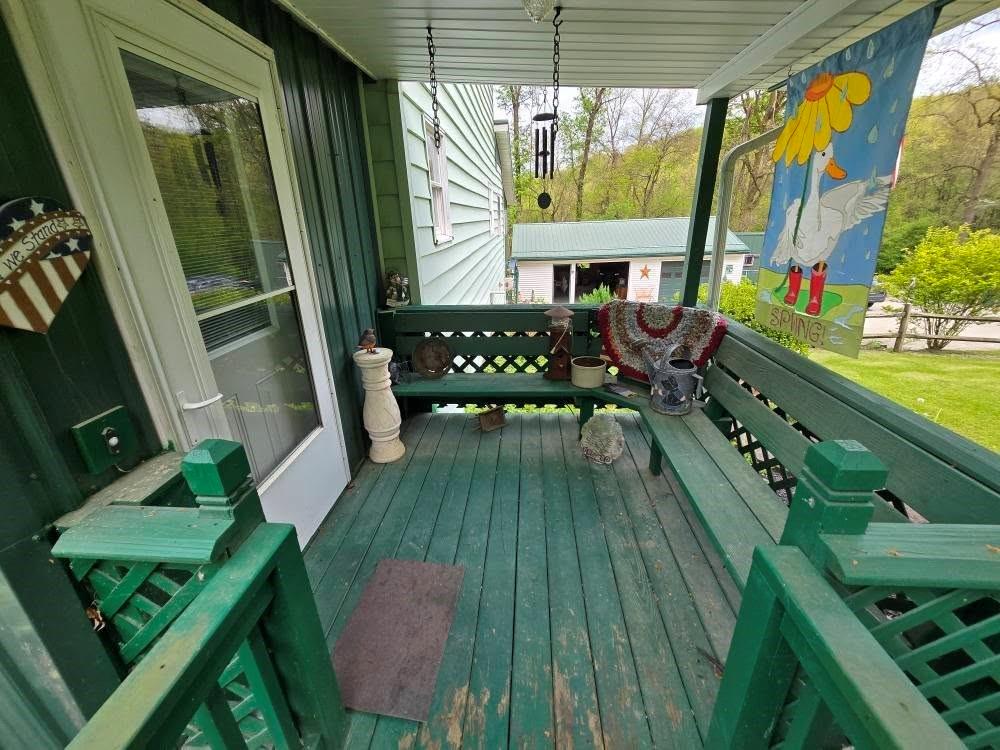 4212 Dayton Road New Bethlehem, PA 16242 - Photo 8 of 31 a balcony with wooden floor table and chairs