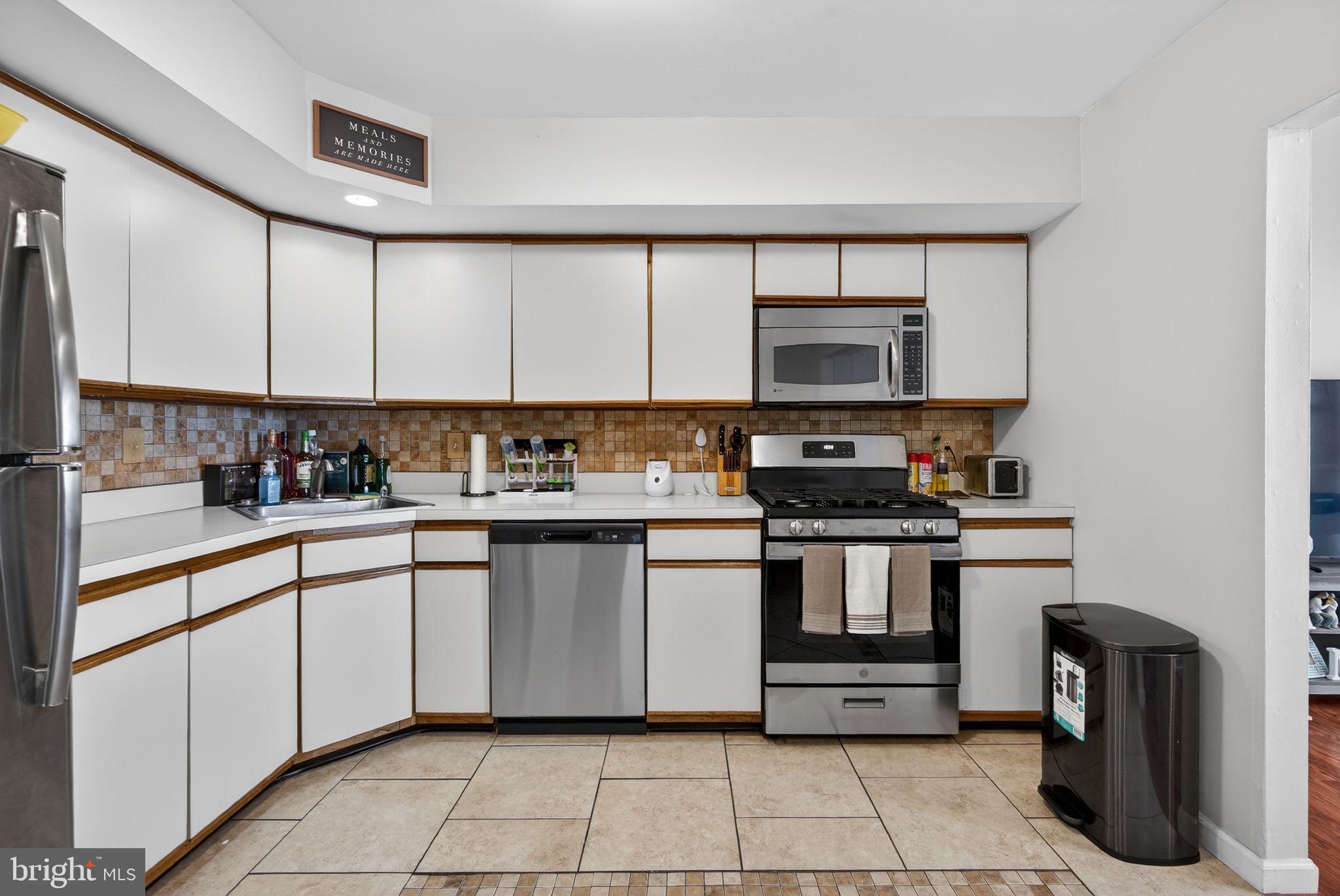 147 Baker Avenue Atco, NJ 08004 - Photo 9 of 31 a kitchen with stainless steel appliances granite countertop a stove a sink and a microwave