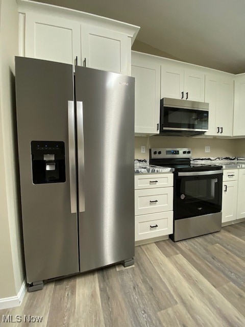 2868 Pressler Road Uniontown, OH 44685 - Photo 11 of 37 Kitchen featuring stove, white cabinets, stainless steel refrigerator with ice dispenser, and light wood finished floors