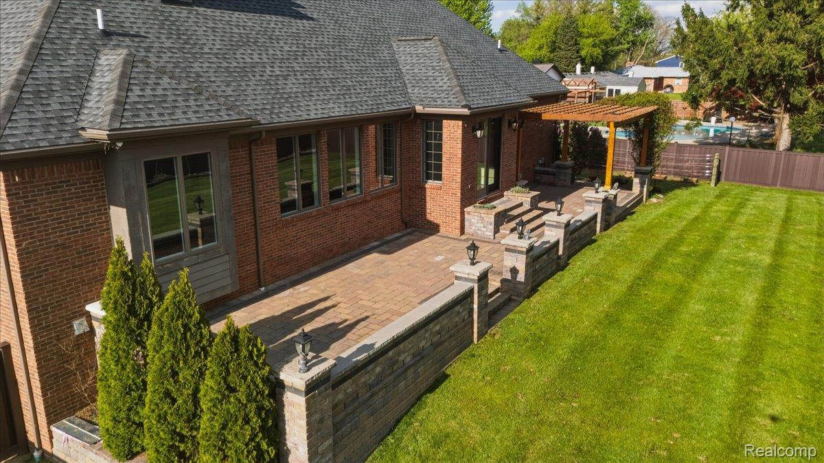 35339 West 13 Mile Road Farmington, MI 48331 - Photo 54 of 72 Rear view of property with a fenced backyard, a patio area, roof with shingles, brick siding, and a pergola