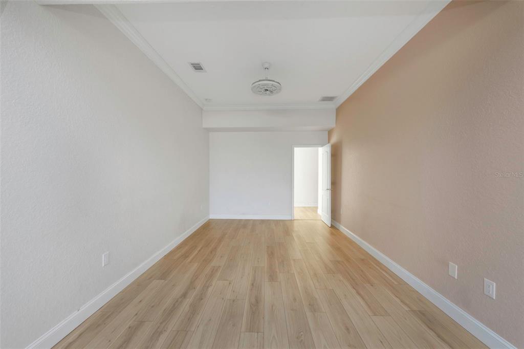 20138 Bowman Road Spring Hill, FL 34610 - Photo 32 of 40 a view of an empty room with wooden floor and a window