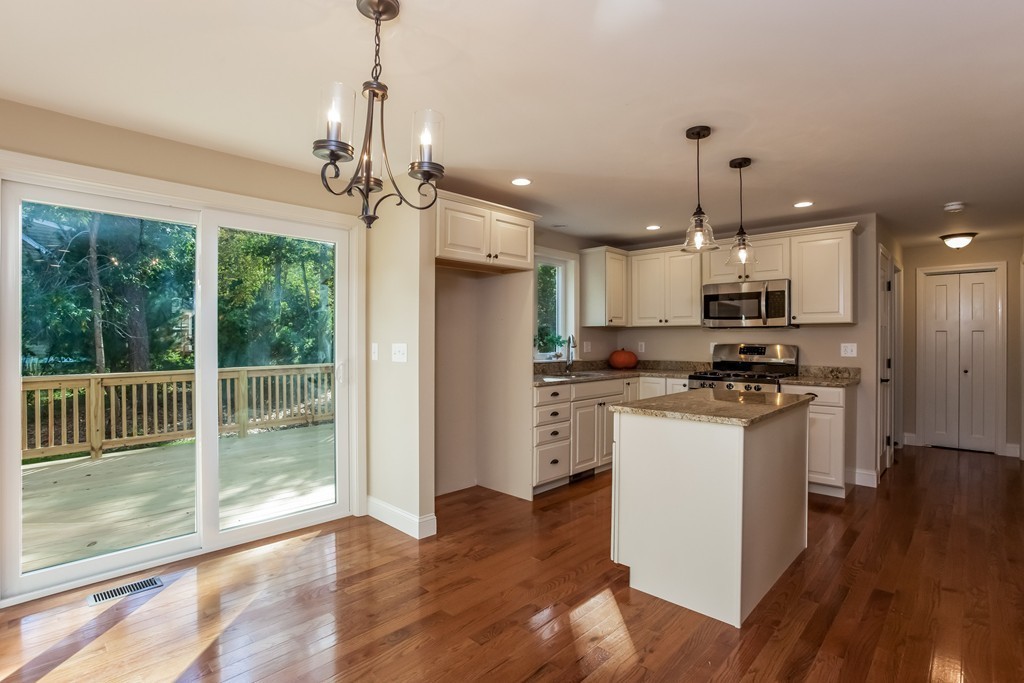 321 Cap'n Lijah's Road Barnstable, MA 02632 - Photo 3 of 10 a kitchen with stainless steel appliances granite countertop a refrigerator a stove a microwave and a wooden floor