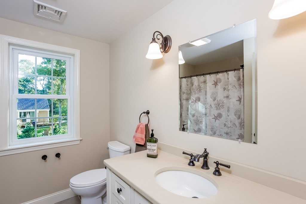 321 Cap'n Lijah's Road Barnstable, MA 02632 - Photo 4 of 10 a bathroom with a toilet sink and mirror