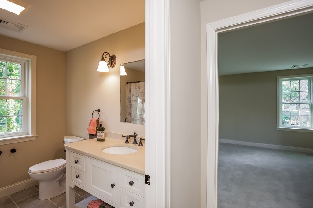 321 Cap'n Lijah's Road Barnstable, MA 02632 - Photo 5 of 10 a bathroom with a toilet sink and mirror