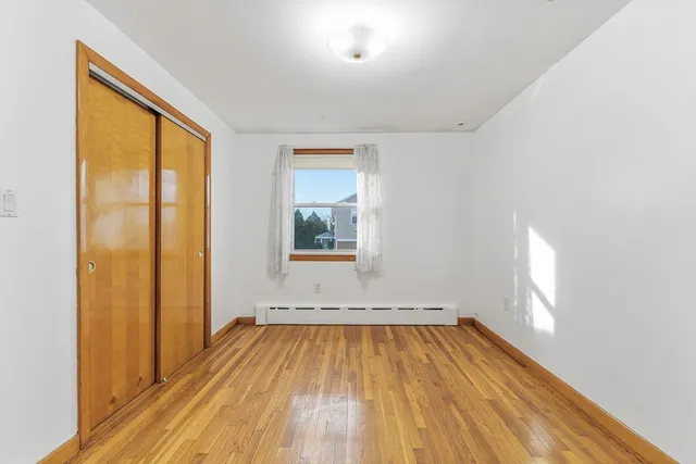 a view of a room with wooden floor and windows