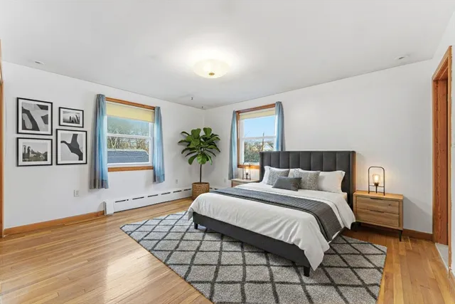 a bedroom with a large bed and a window