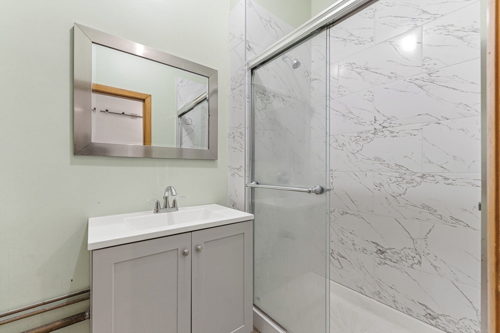 7 Carol Street Stoneham, MA 02180 - Photo 17 of 28 a bathroom with a sink and mirror