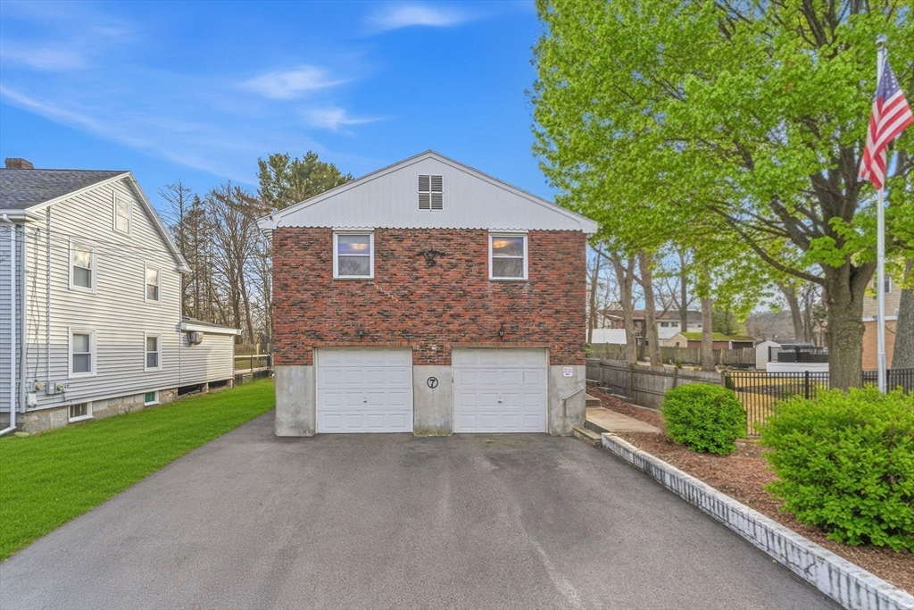 7 Carol Street Stoneham, MA 02180 - Photo 26 of 28 a front view of a house with a yard and garage