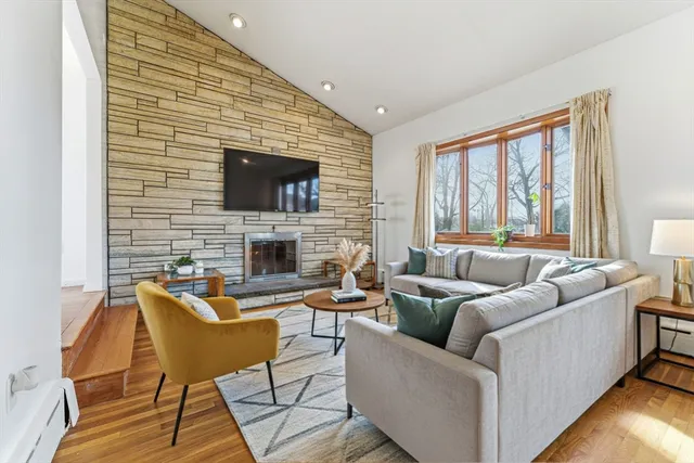 a living room with fireplace furniture and a flat screen tv