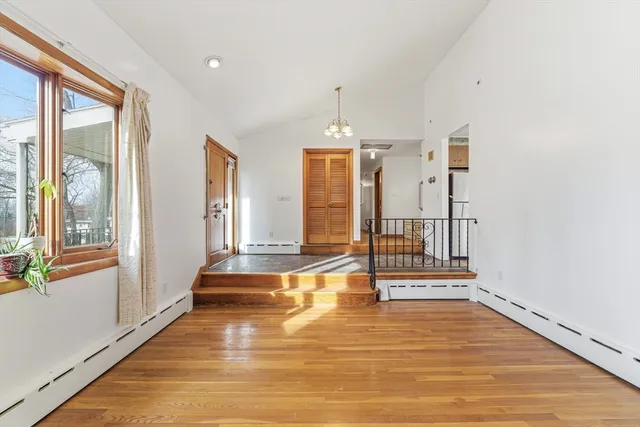 a view of a room with wooden floor and windows