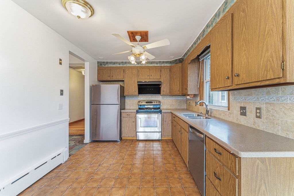 7 Carol Street Stoneham, MA 02180 - Photo 6 of 28 a kitchen with granite countertop a refrigerator oven a sink dishwasher and a stove