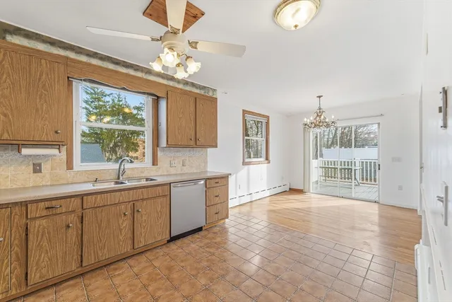 a view of a double vanity sink a mirror and a window