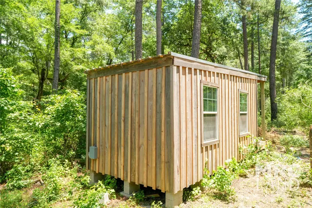 a view of a house with a backyard and garden