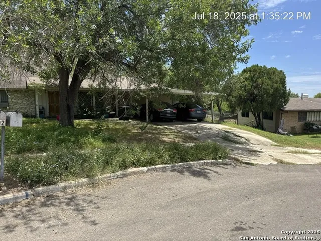 a view of a house with a yard and garage