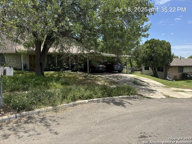 a view of a house with a yard and garage