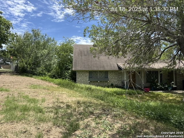 206 Threadneedle Lane San Antonio, TX 78227 - Photo 2 of 4 a view of a backyard with plants and large tree