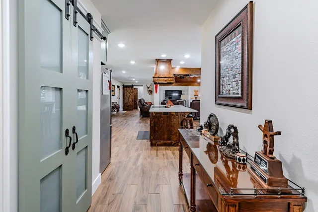 a spacious bedroom with a bed and a chandelier