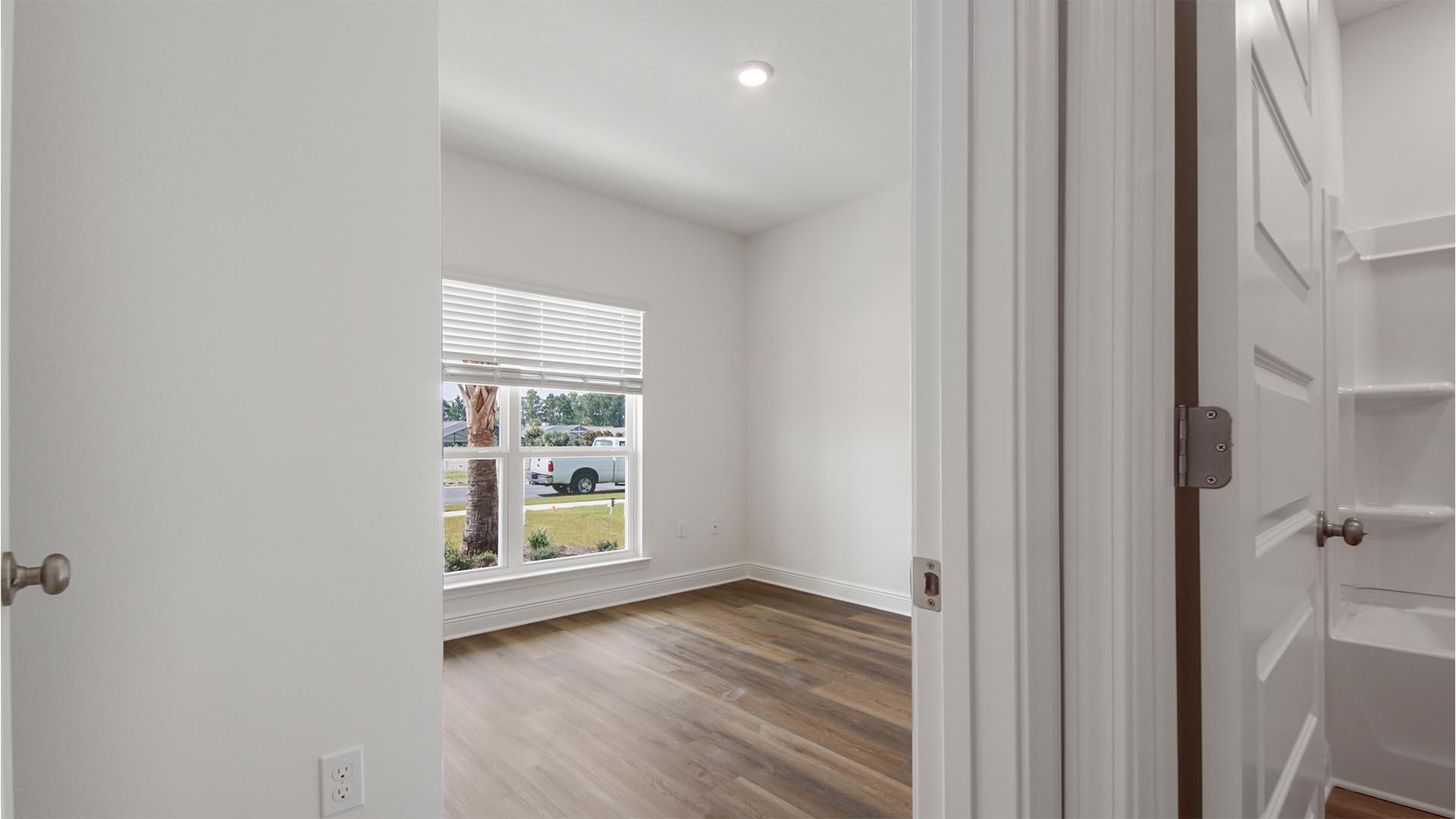363 Holley Grv Lane Santa Rosa Beach, FL 32459 - Photo 25 of 37 a view of an empty room with a window and wooden floor