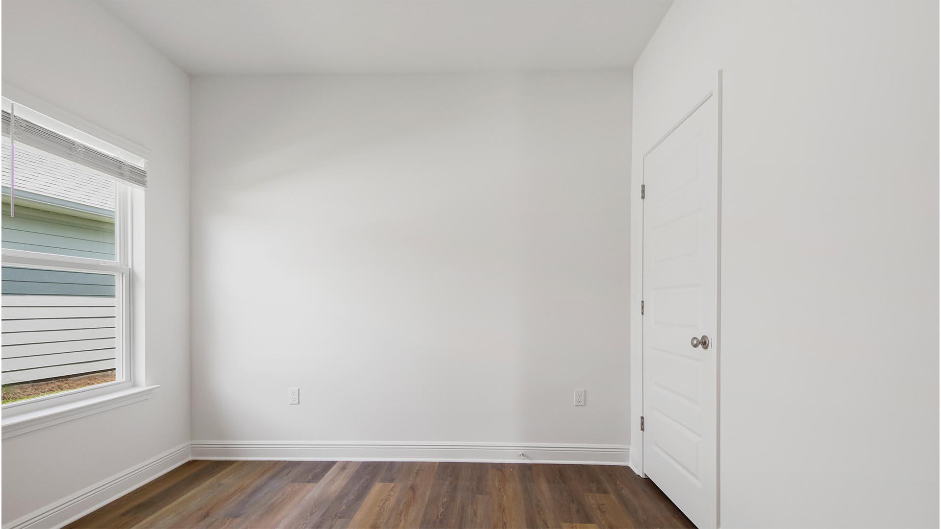 363 Holley Grv Lane Santa Rosa Beach, FL 32459 - Photo 32 of 37 a view of an empty room with wooden floor and a window
